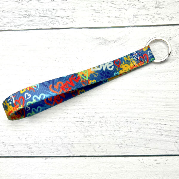 Colorful "Love" graffiti-style dog on blue keychain by 2 Hounds Design. - Earthstyle